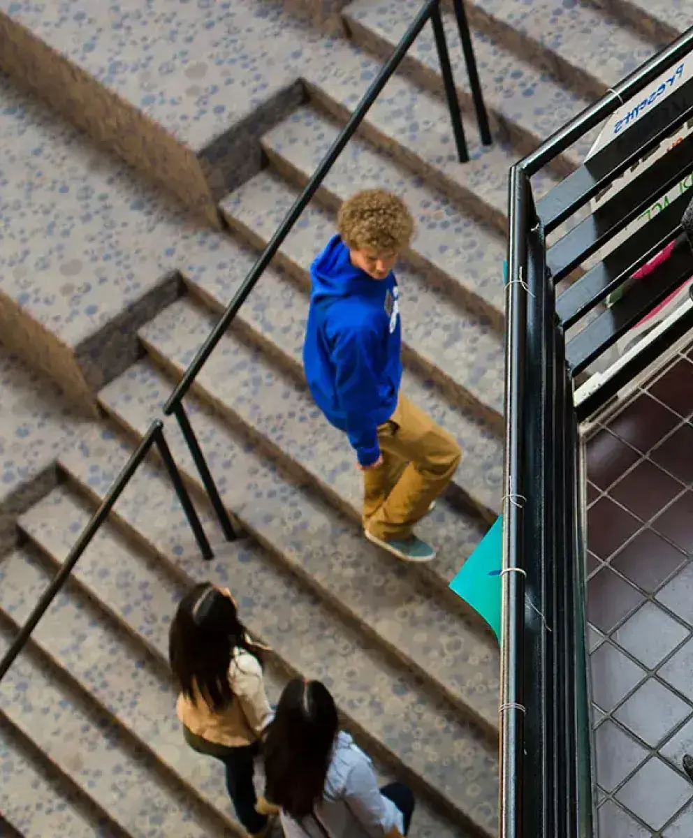Birds Eye view inside Students Union with students walking and studying.