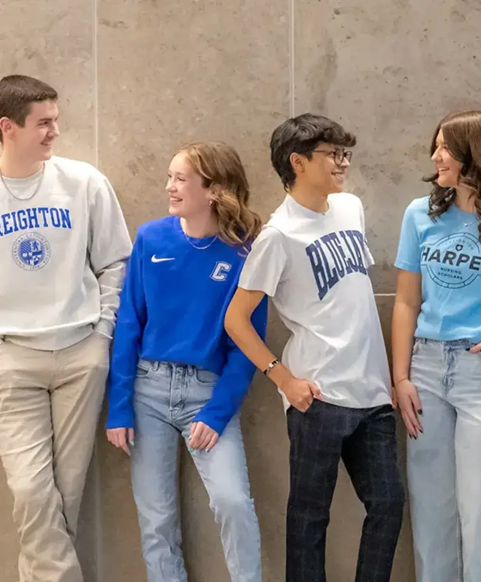 Creighton students gathered against a wall.