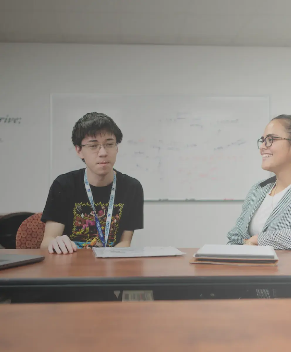 Student talking to staff member