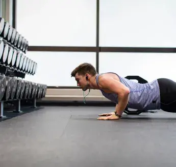 Student doing pushups in the weight room