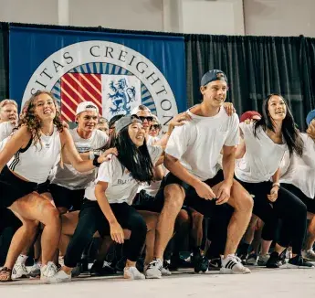 Students in unity dancing on stage setting.