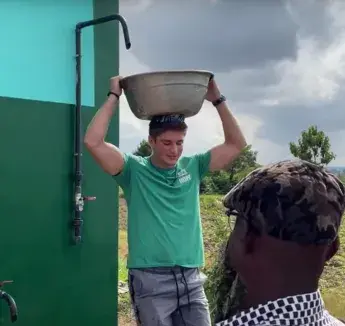 Cooper Idt carry water bowl on his head.