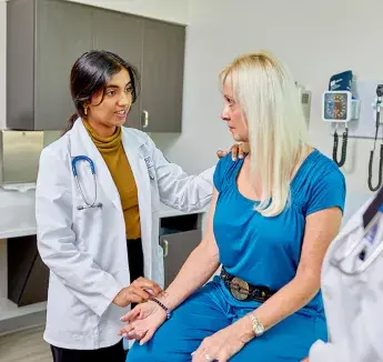 Caring for standardized patient by taking pulse.