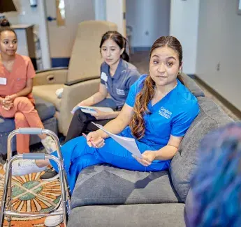 Meeting with patient in lounge setting.
