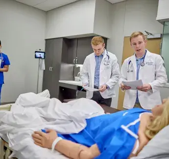 Consulting with patient in care room.