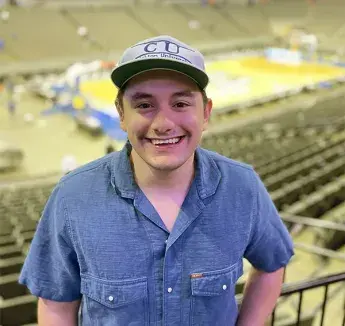 Dominic Jasso smiling and posing at Creighton basketball pregame.
