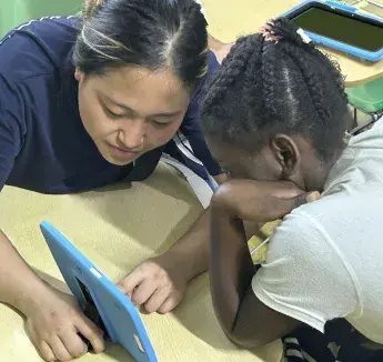 Creighton student working with young person.