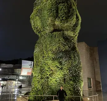 student in front of statue