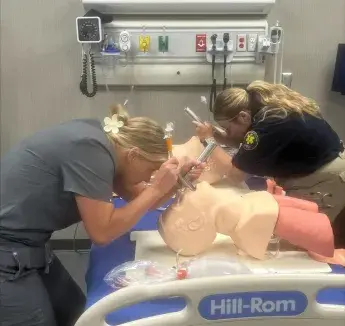 Two students practicing clinical skills together
