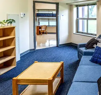 McGloin living area with couch and bookshelf.