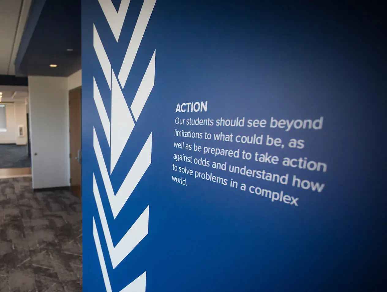 Students should see beyond tagline on wall