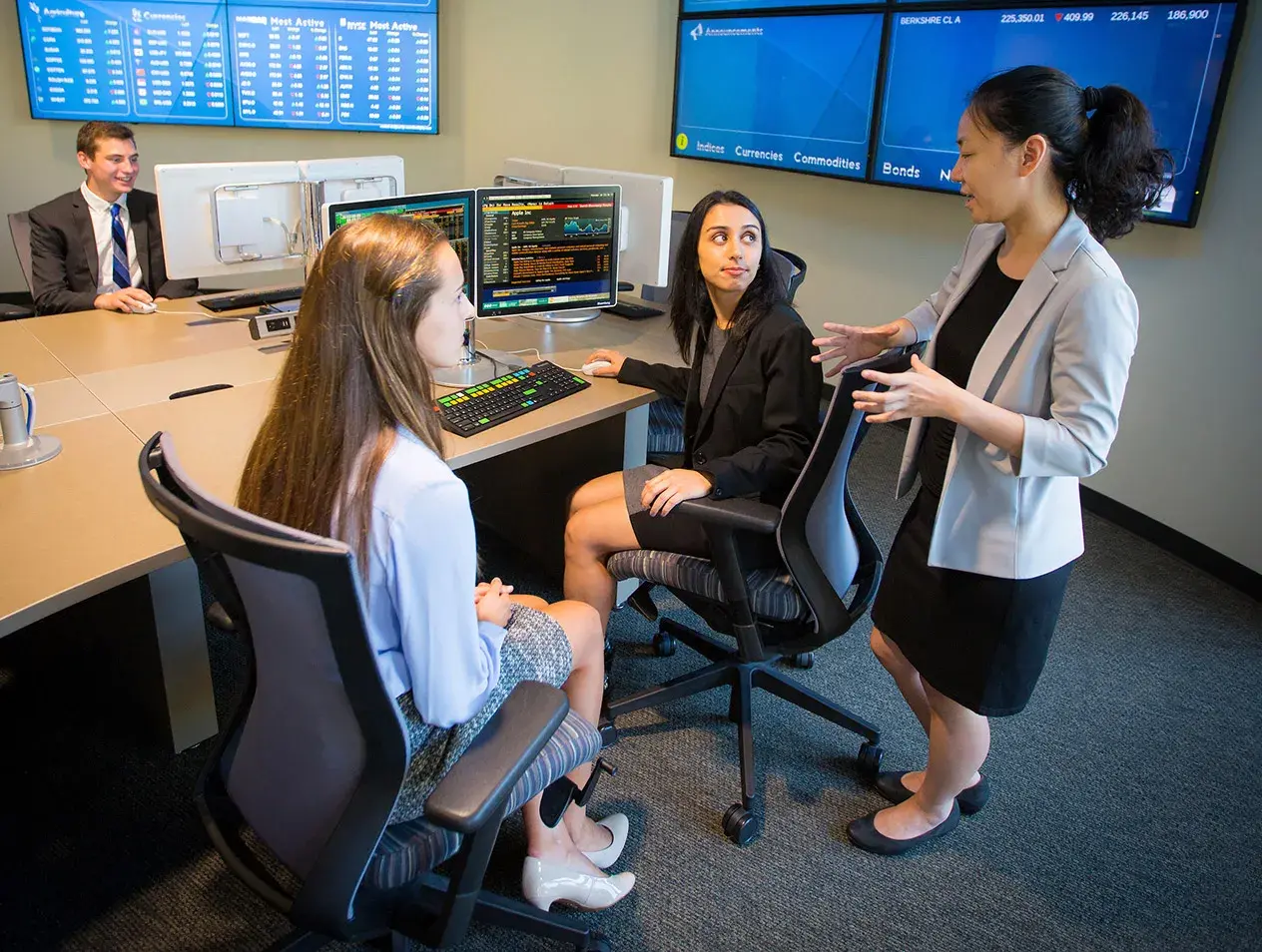 Three business professionals having a discussion in front of a computer