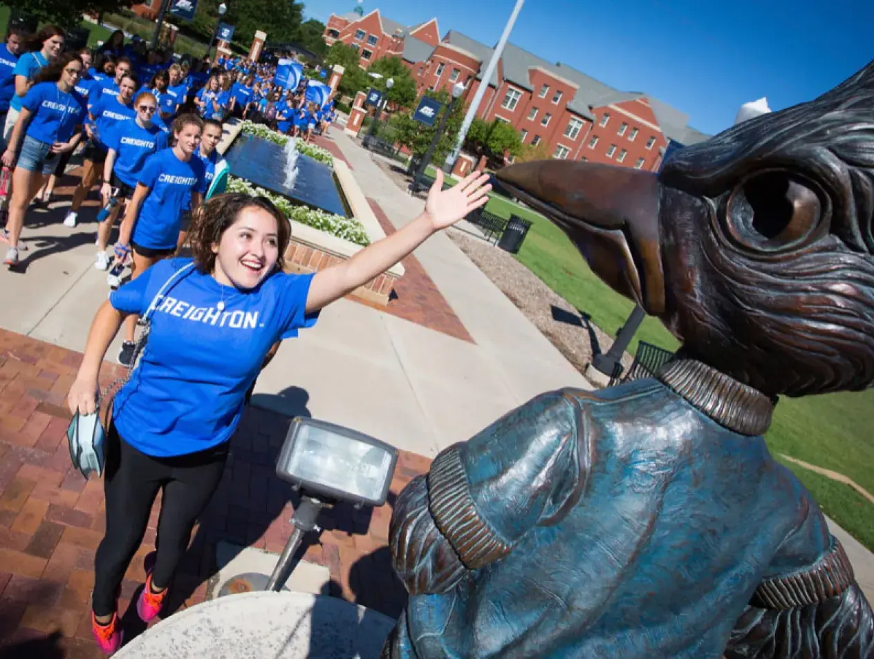 Female student slapping Billy Bluejay beak.