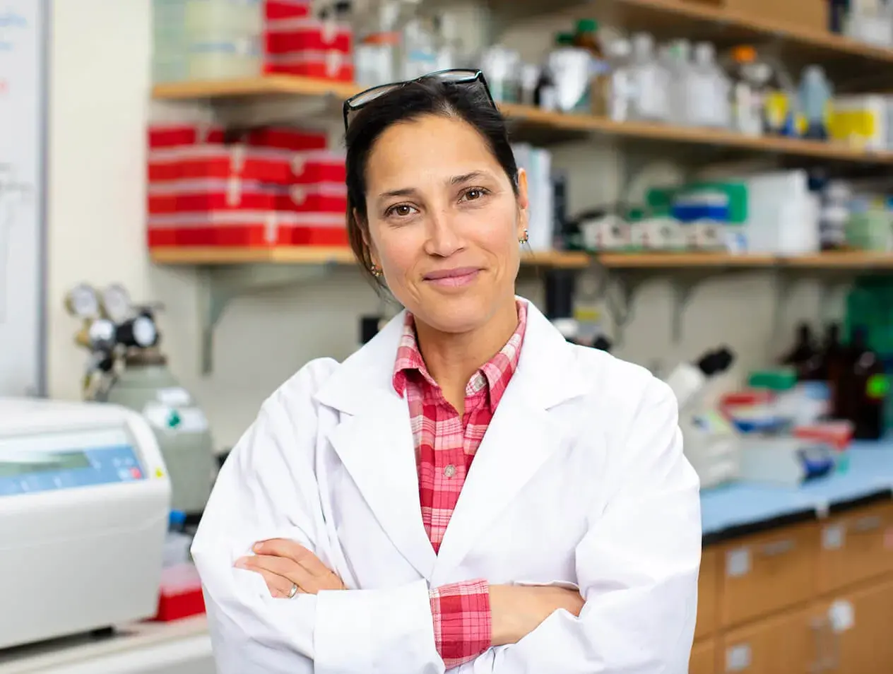 A cancer researcher standing in a lab