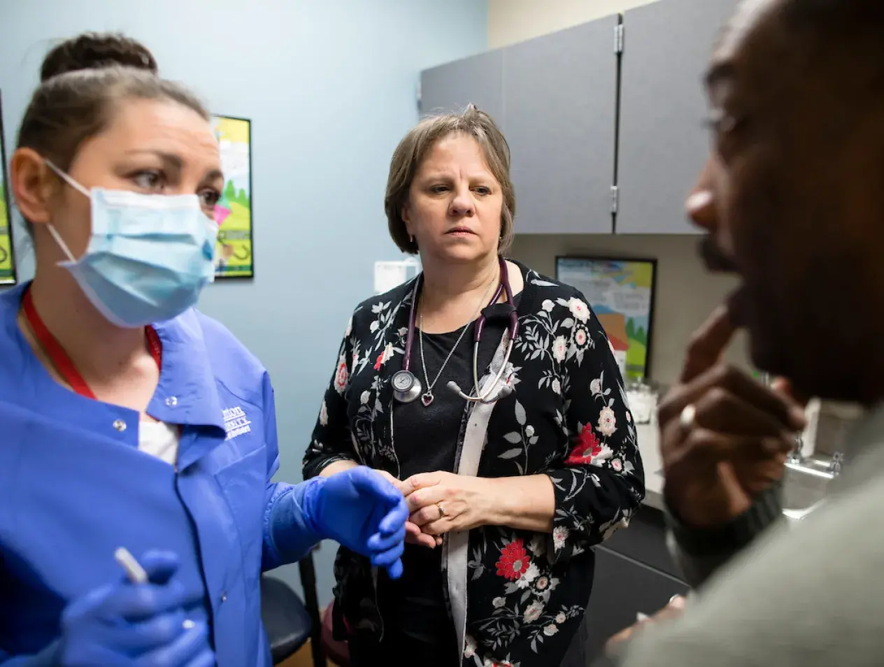 Faculty member Martha Todd with student and patient