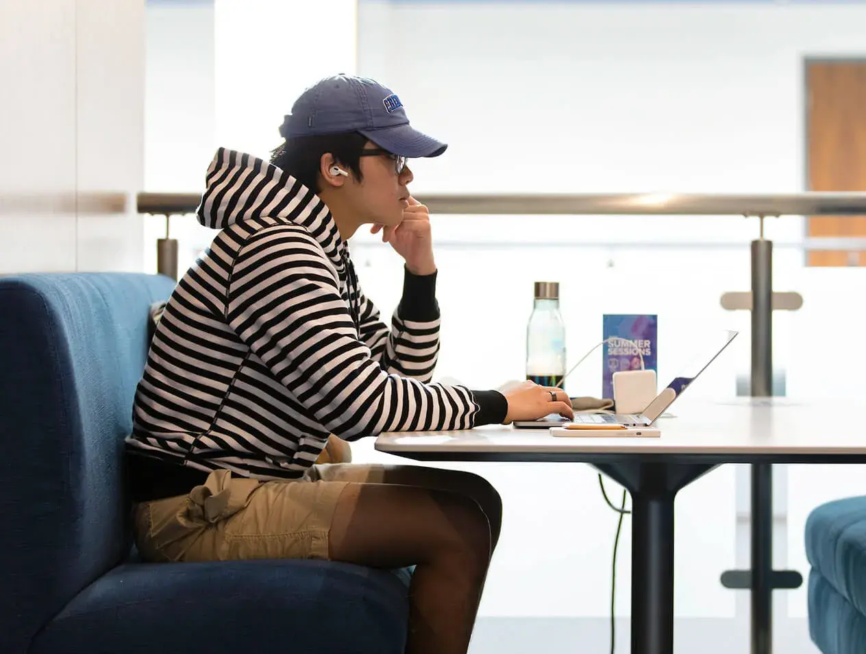Creighton student studying on a laptop at a table