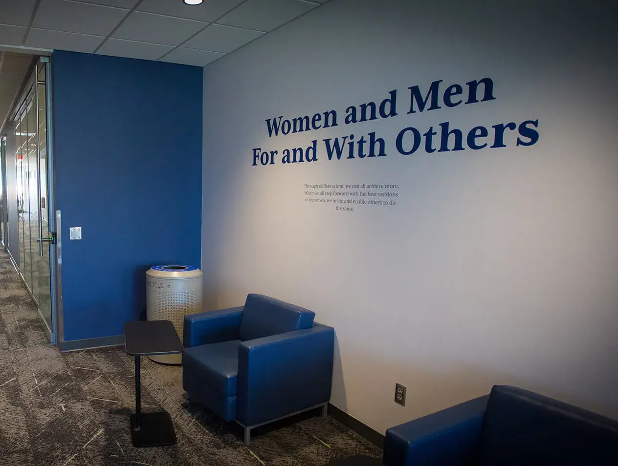 Women and Men For and With Others tagline on wall 