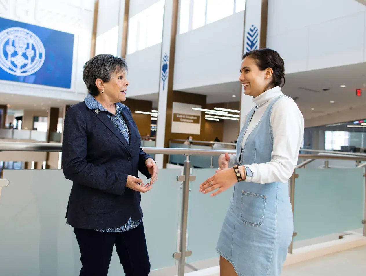 Business faculty and student in discussion at Heider College of Business