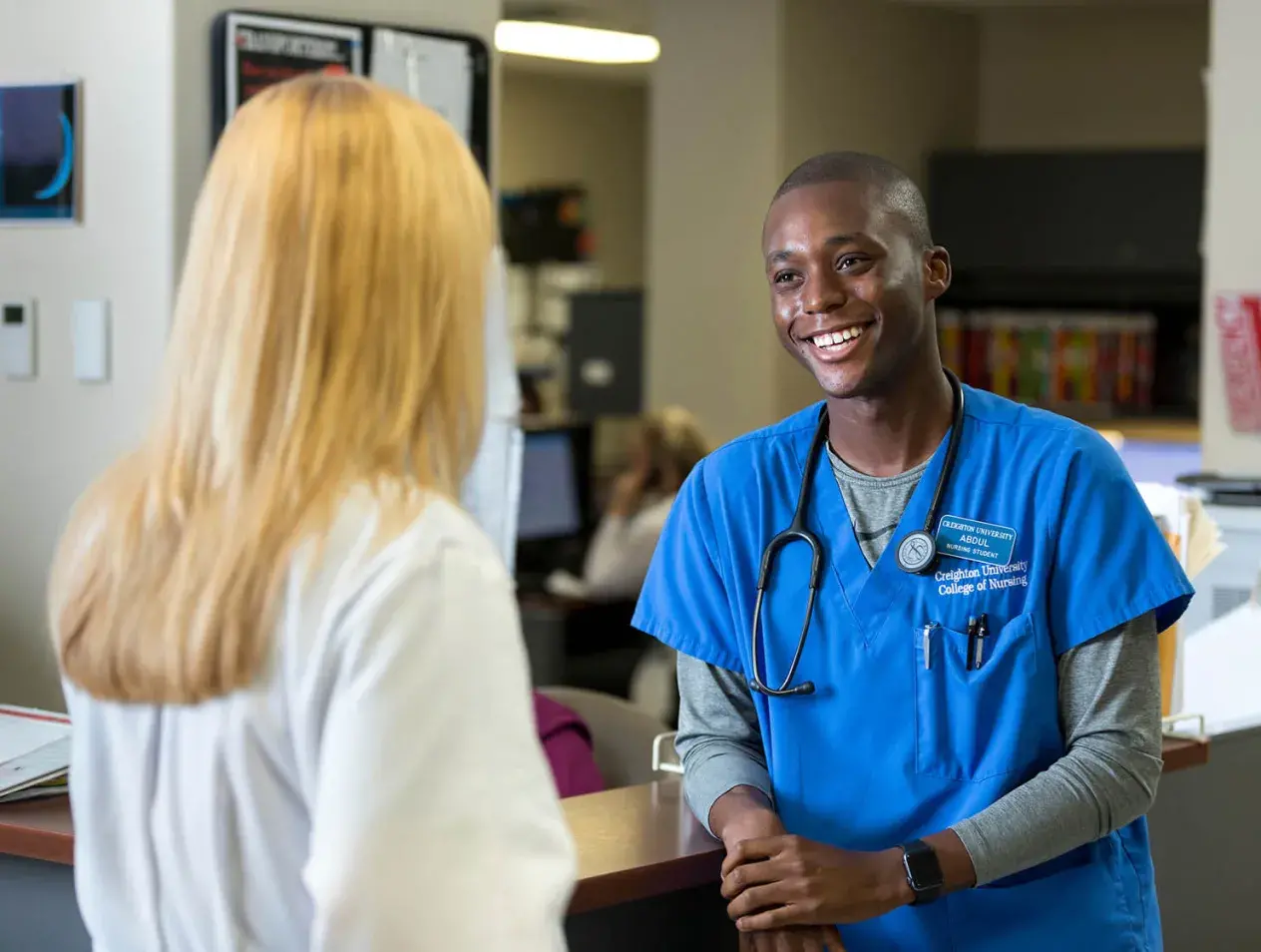 A nursing student speaking to a doctor