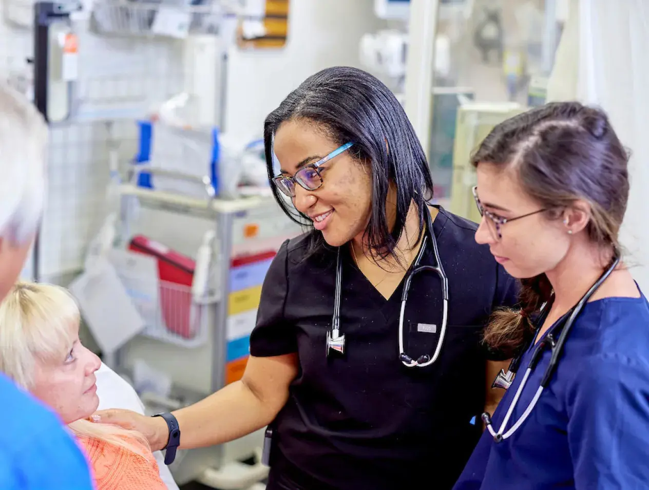 Medical staff working with patients in hospital room