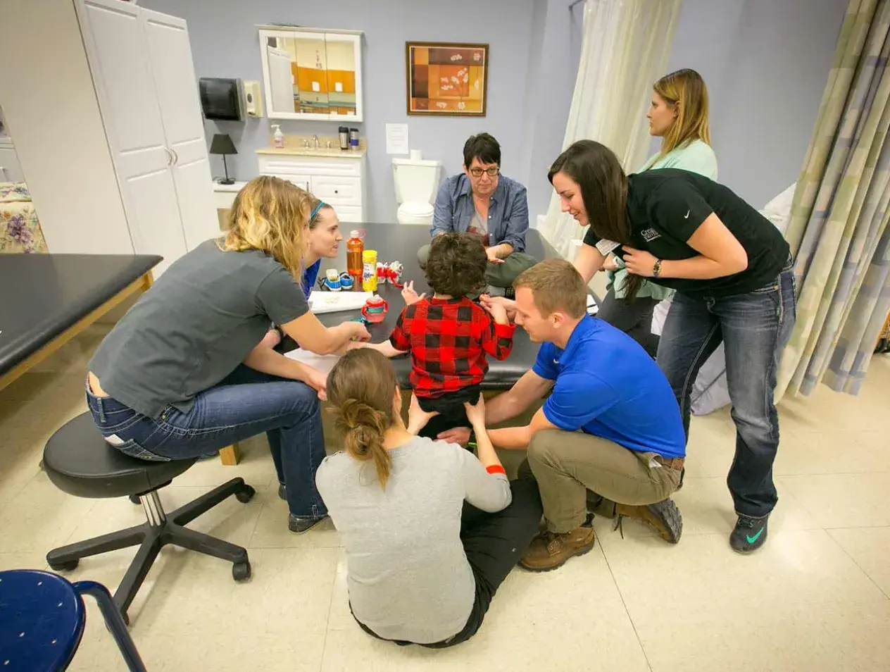 Interprofessionals collaborating with child patient 