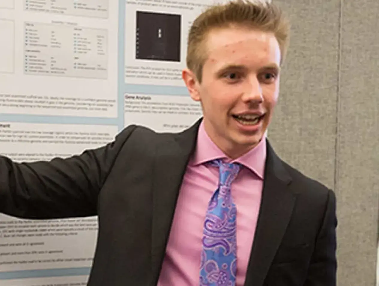 Student presenting research poster