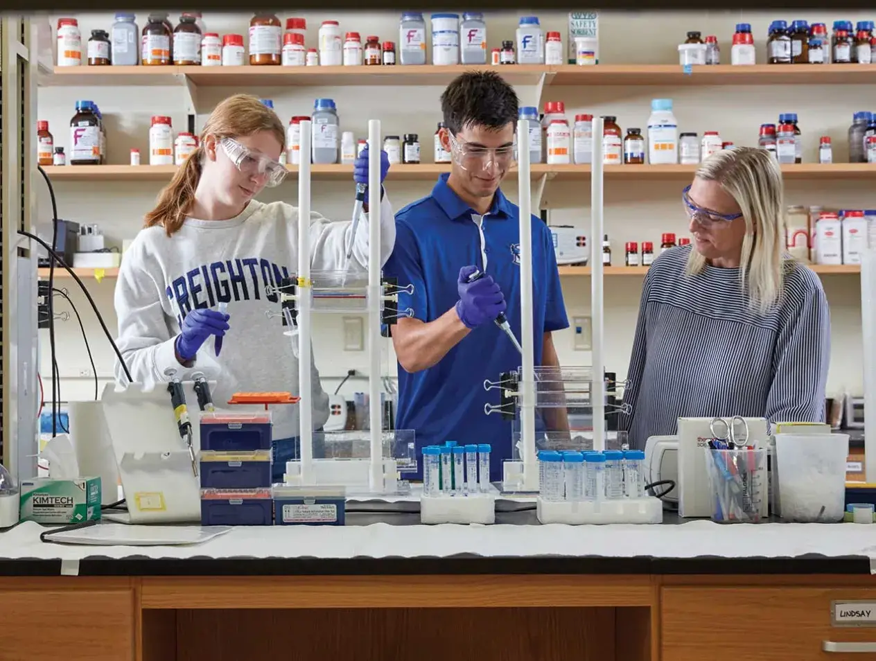 3 students using lab equipment
