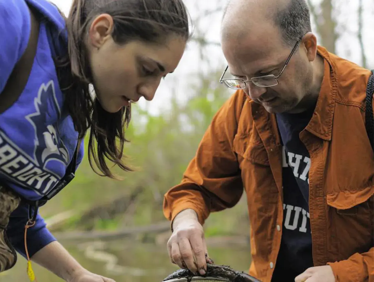 Faculty and student doing field research