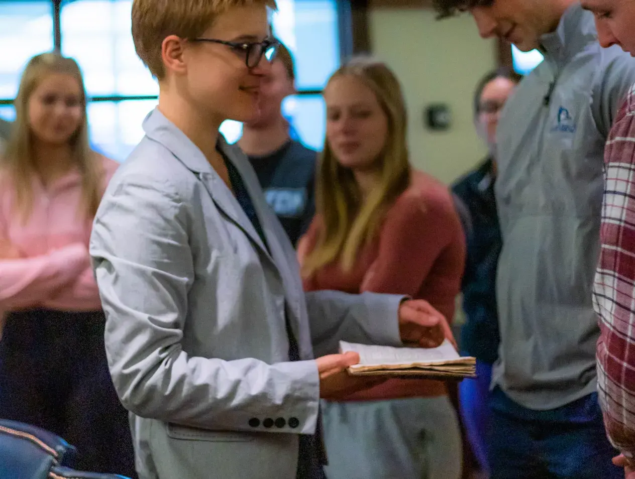 Dr. Ross shows students a rare book.