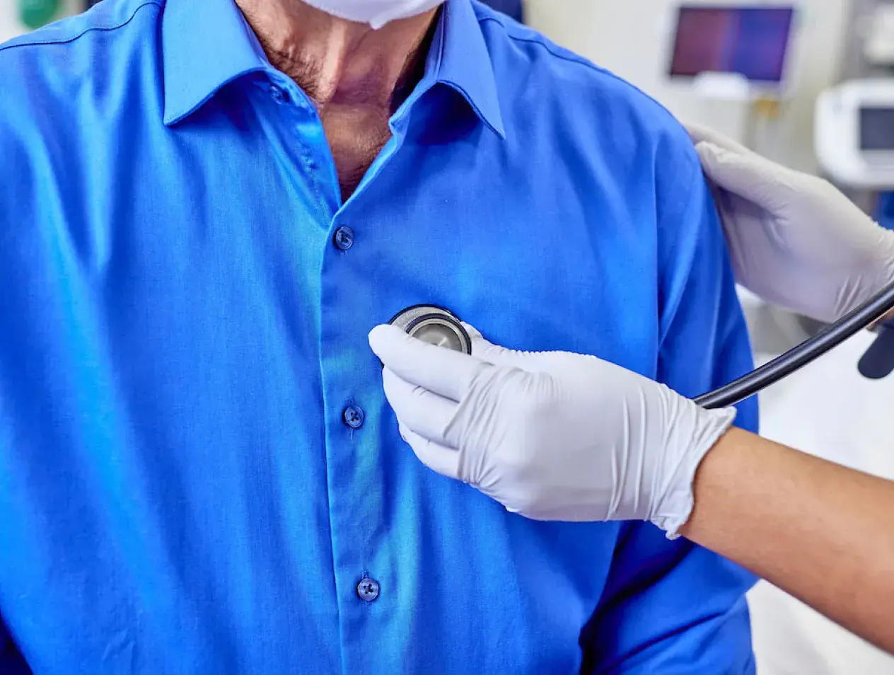 Patient being examined with stethoscope.