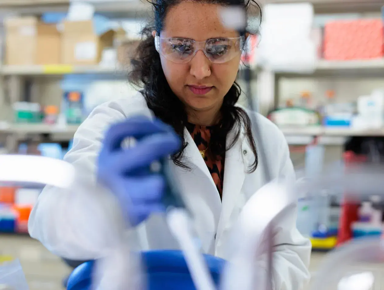 student in lab using pipette