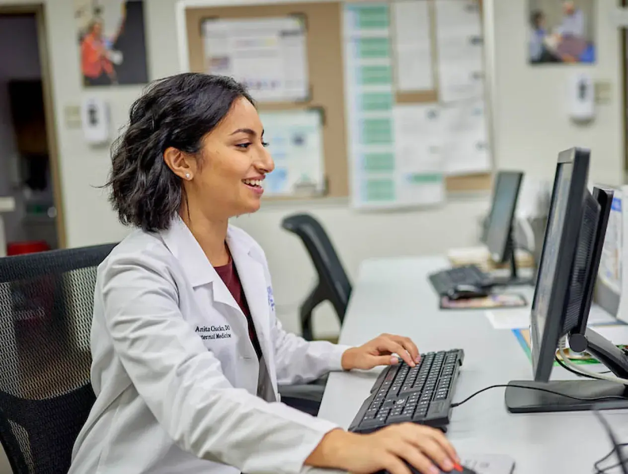 Healthcare worker studying data on computer.