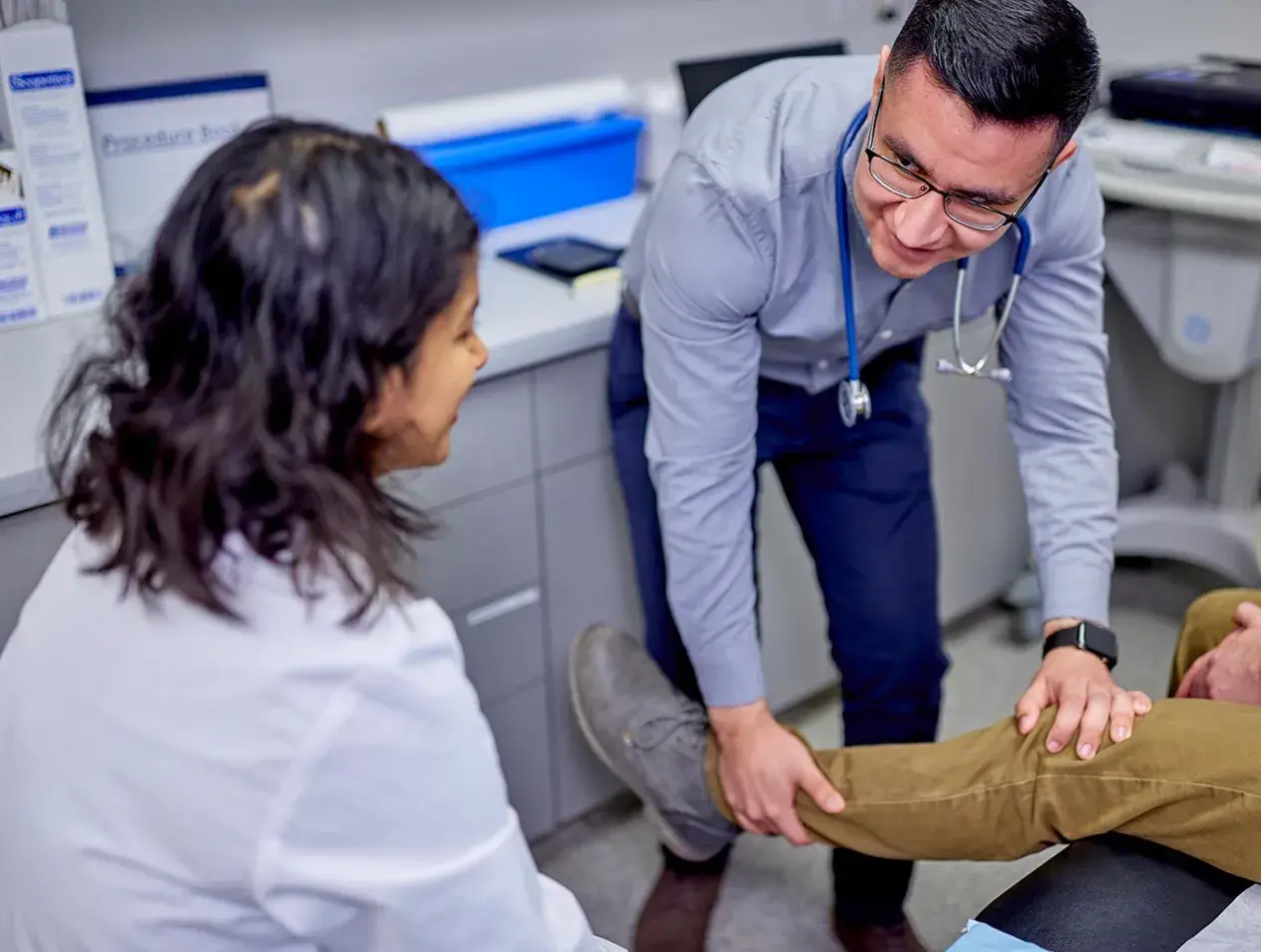 Doctor and assistant examining a patient's leg