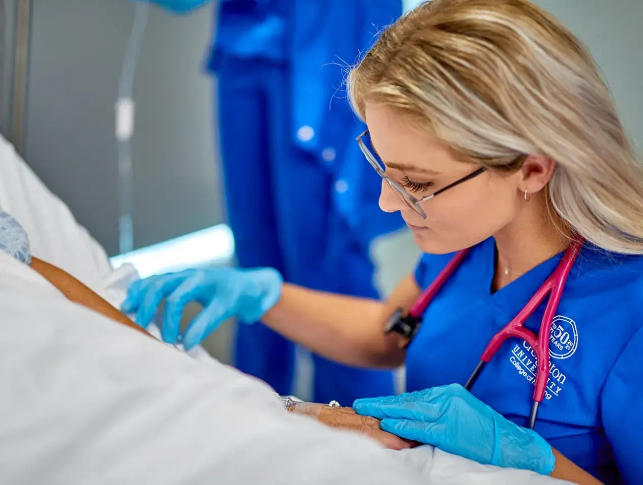 Nurse checking IV in patient
