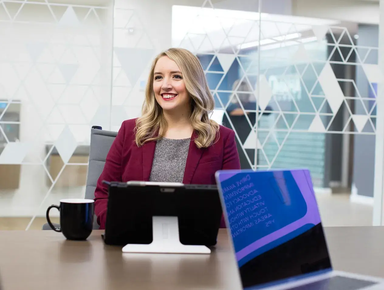 Professional woman sitting at table in conference room