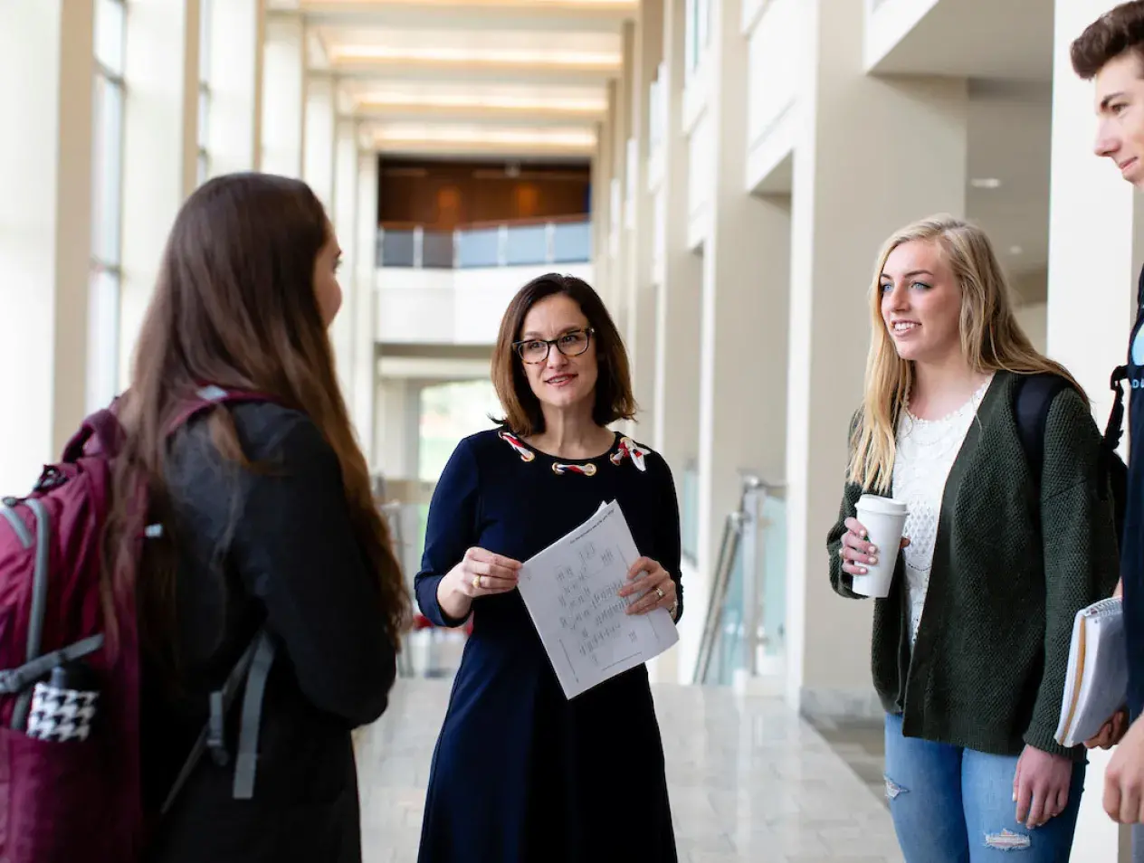 Mary Dana Laird talking with students in Heider College of Business.