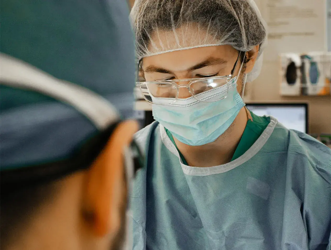 Surgery resident doing surgery