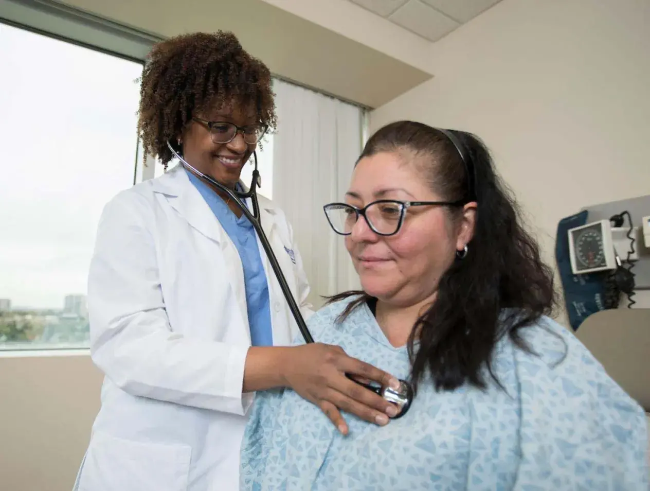 Doctor with stethoscope checking patient