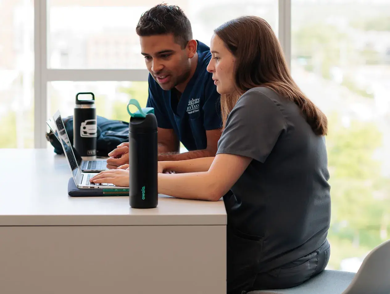 Dental students looking at laptop 