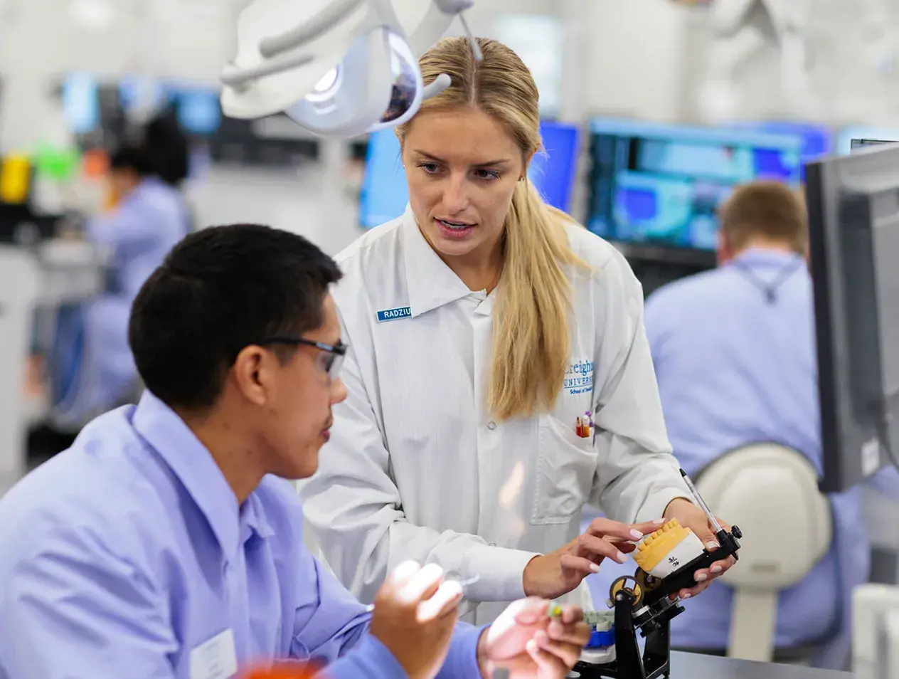 Dental student and professor talking