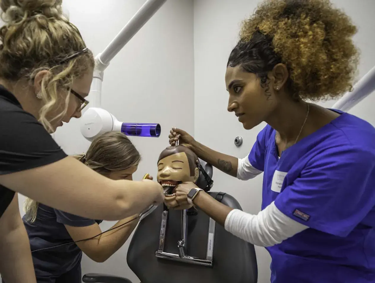 Dental students working in simulation lab.