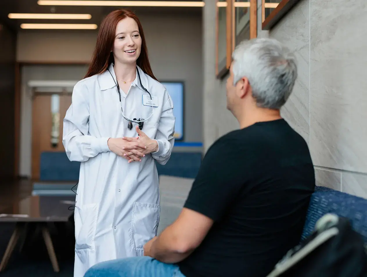 Dental student talking to patient