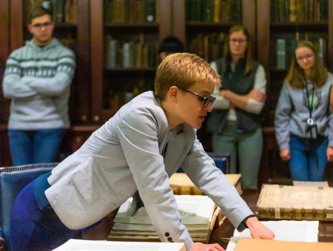 Dr. Ross shows students a rare book.