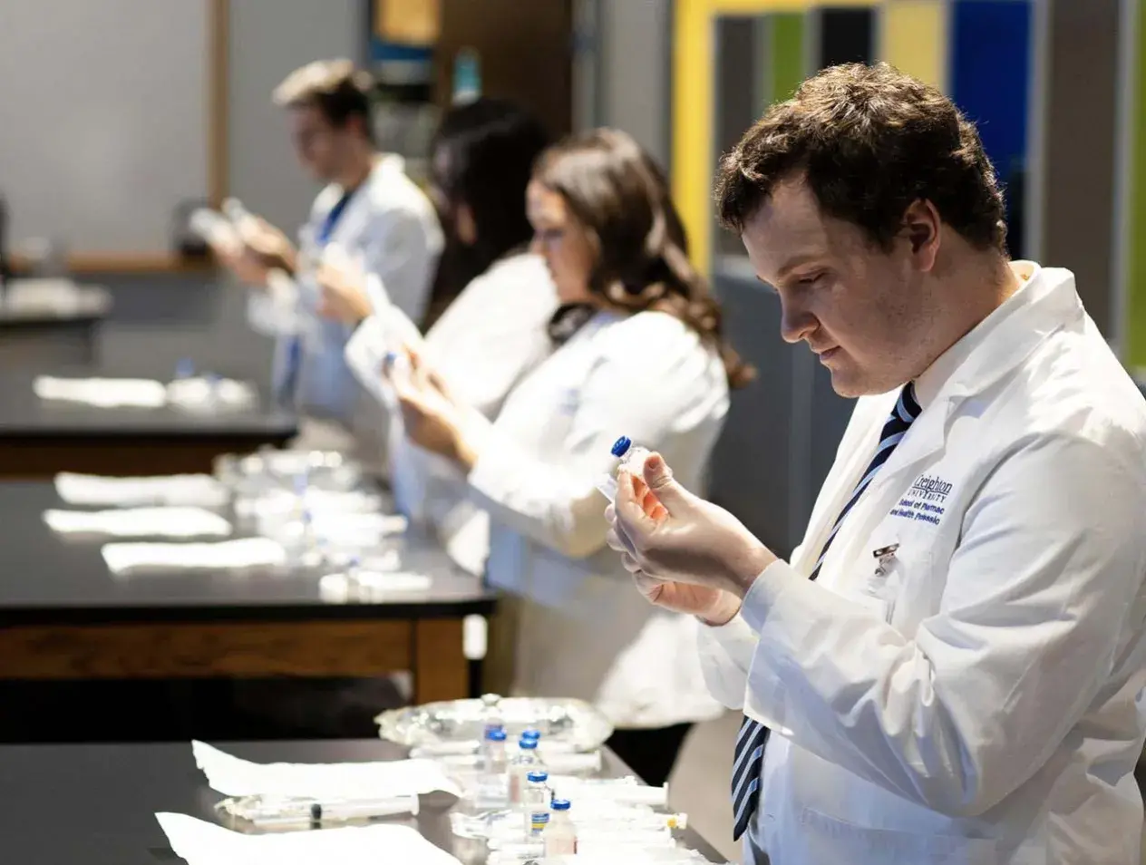 pharm student looking at vial