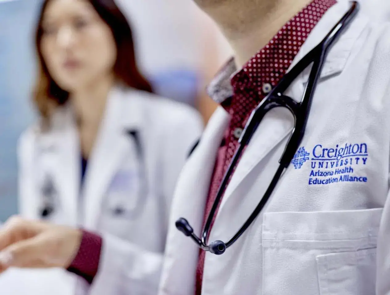Residents in white coats with stethoscopes.