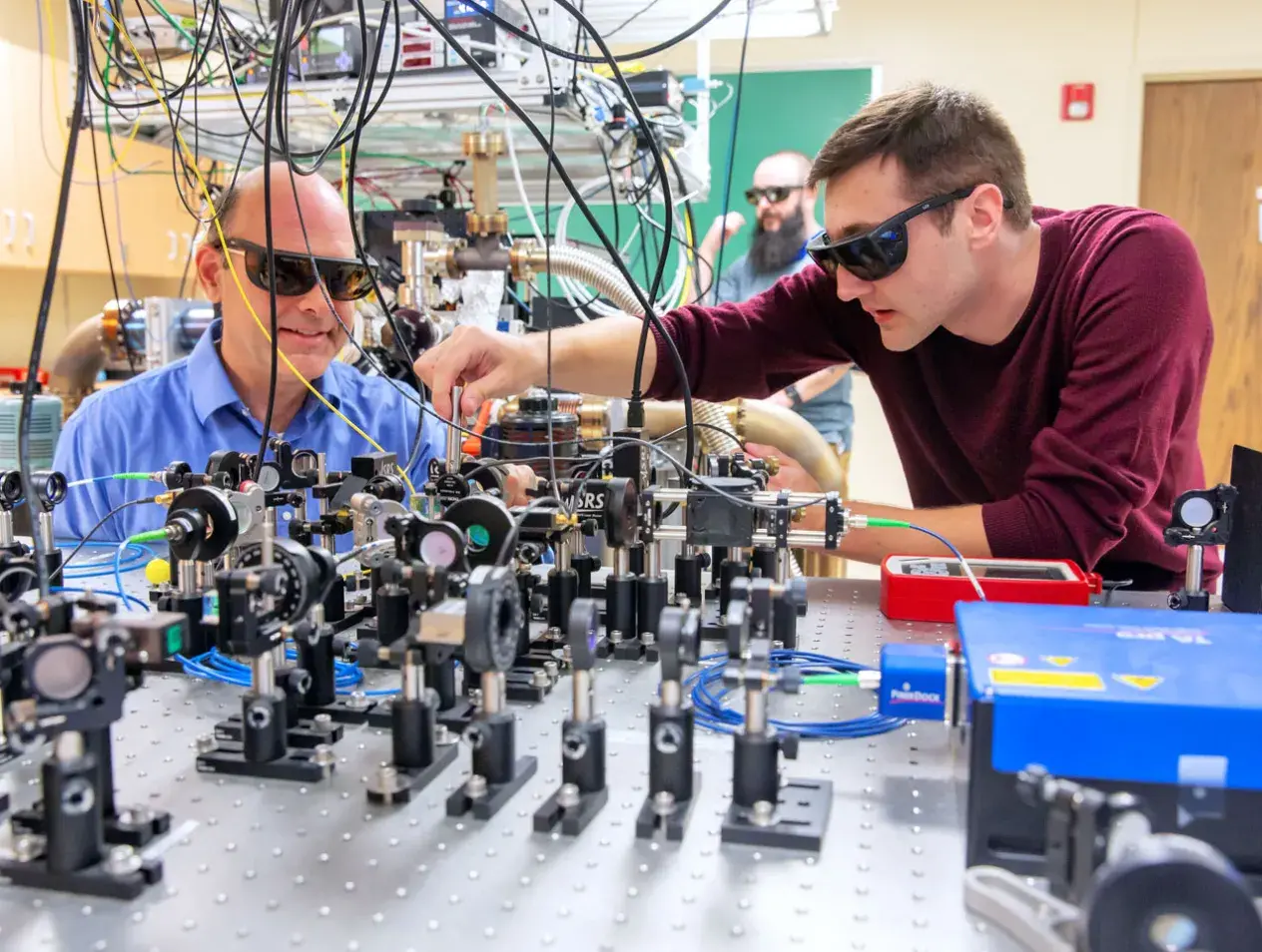 Physics faculty and student working in lab