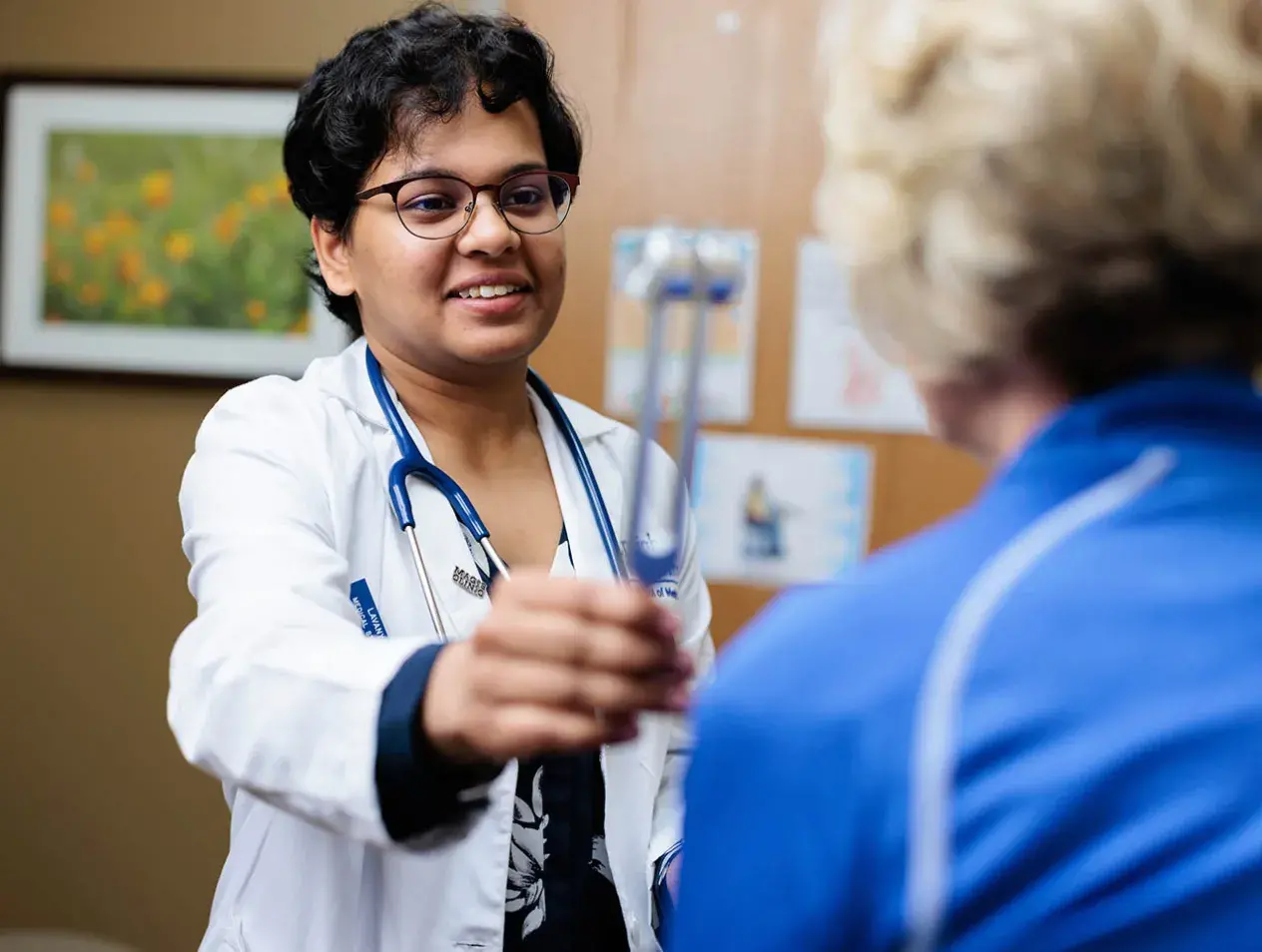 Doctor examining patient with stethoscope.