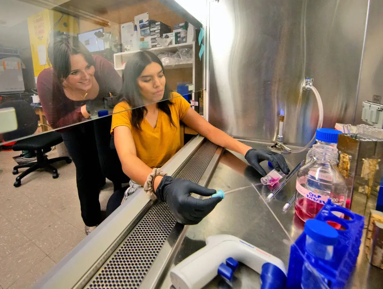 Undergraduate physics student in lab with faculty