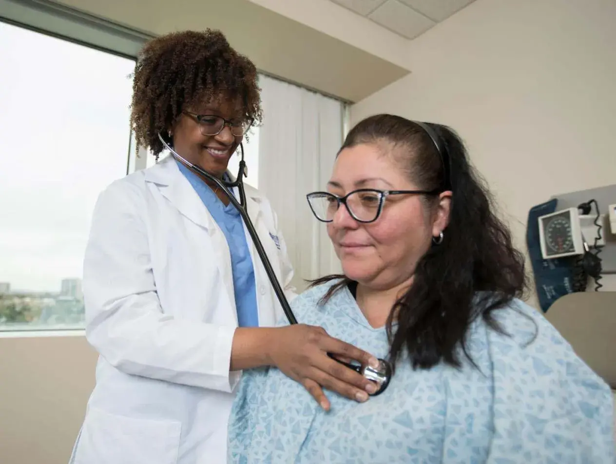 Examining patient in hospital room