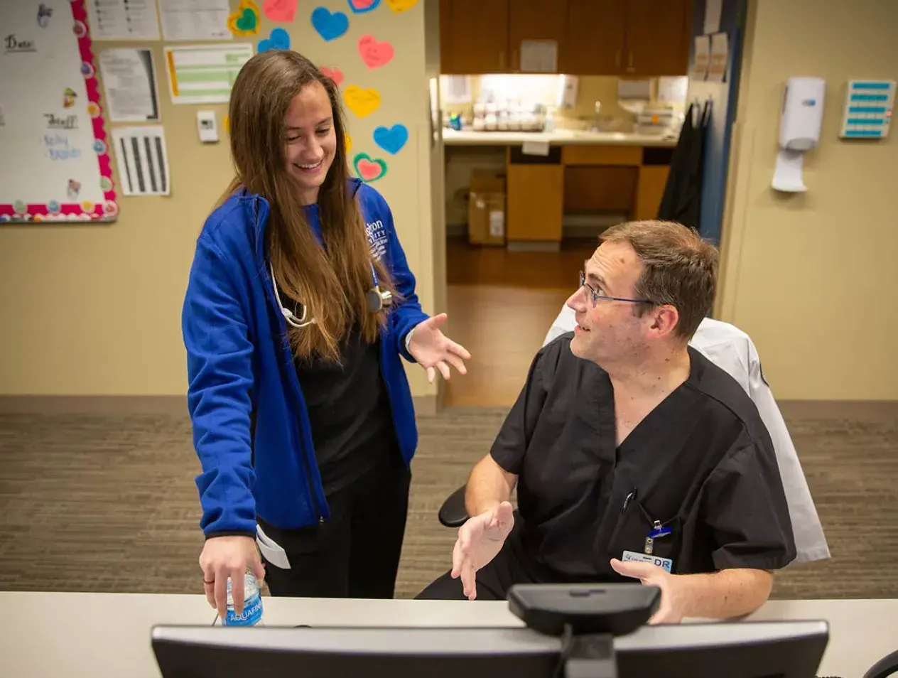 Infectious disease fellows at computer